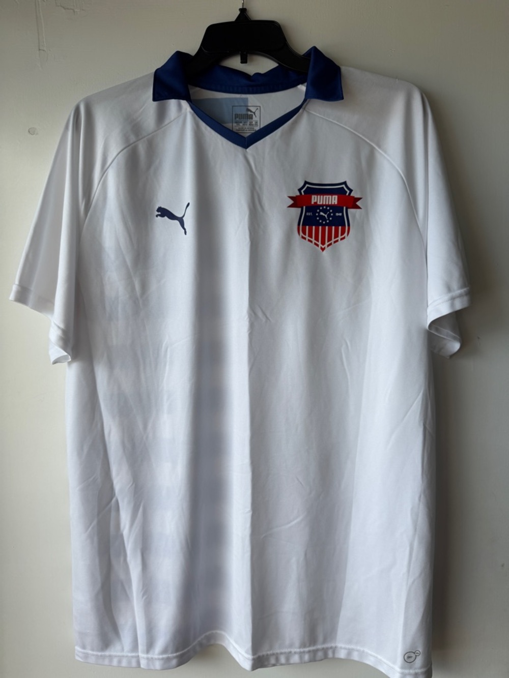 Puma White Soccer Jersey with Blue Collar and Red Shield Crest